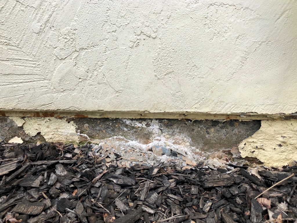 Closeup of crumbling wall on the foundation of a home.